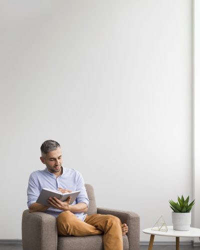 man writing his agenda copy space